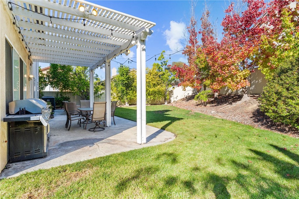 8705 Running Springs Drive Anaheim, CA 92808 - Photo 26 of 37 a view of a patio with a table chairs and a backyard