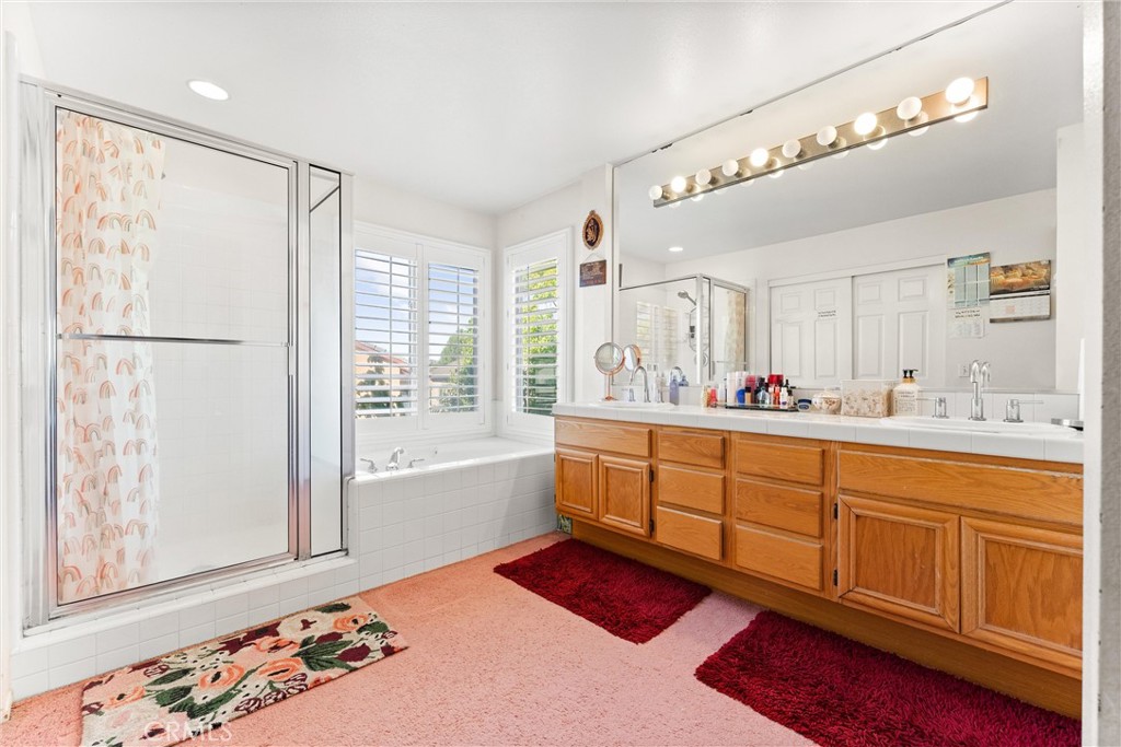 8705 Running Springs Drive Anaheim, CA 92808 - Photo 32 of 37 a spacious bathroom with a double vanity sink mirror and bathtub
