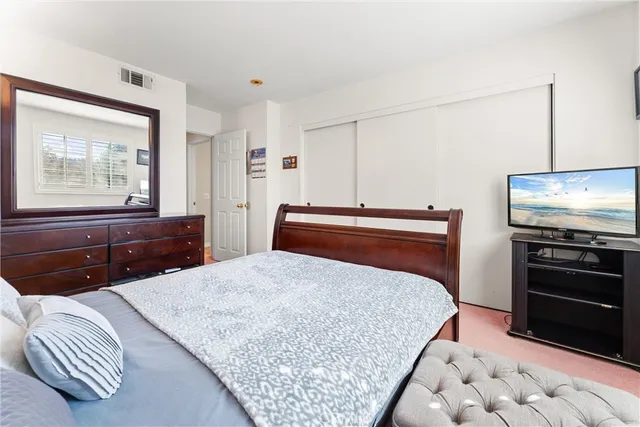 a bedroom with a bed and a television