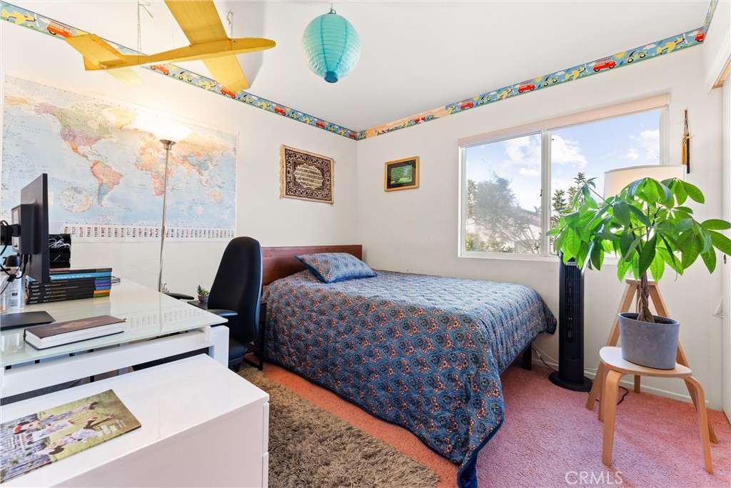 8705 Running Springs Drive Anaheim, CA 92808 - Photo 35 of 37 a bedroom with a bed a couch and a potted plant