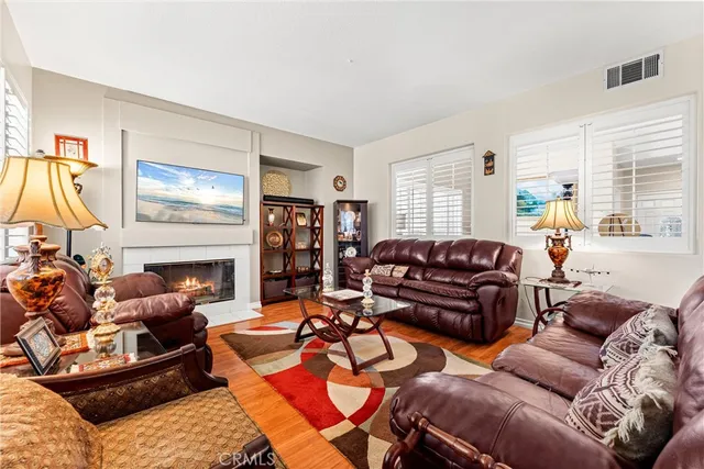 a living room with furniture a fireplace and a flat screen tv