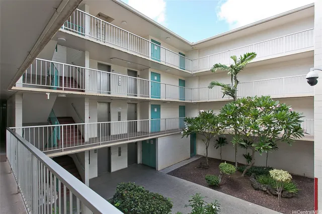 a balcony with potted plants and wooden floor