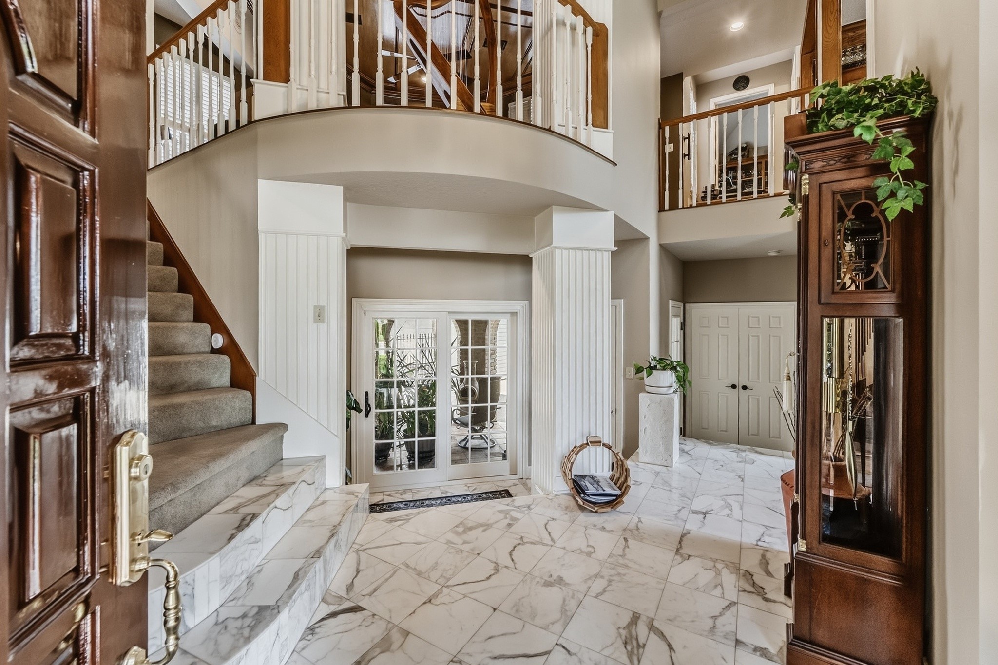 6047 Spring Creek Lane Spring, TX 77379 - Photo 2 of 50 A sweeping marble entry and sweeping staircase create a striking first impression rooted in classic European design. From the ironwork details to the soaring ceiling above, every element was chosen with a sense of permanence and grace.