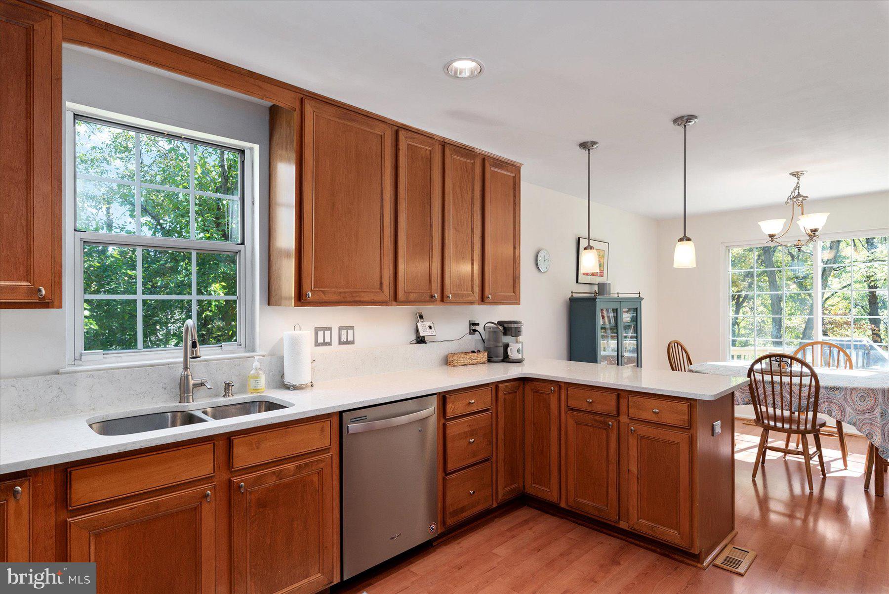 9337 Spring Water Path Jessup, MD 20794 - Photo 11 of 41 a kitchen with a sink window and cabinets