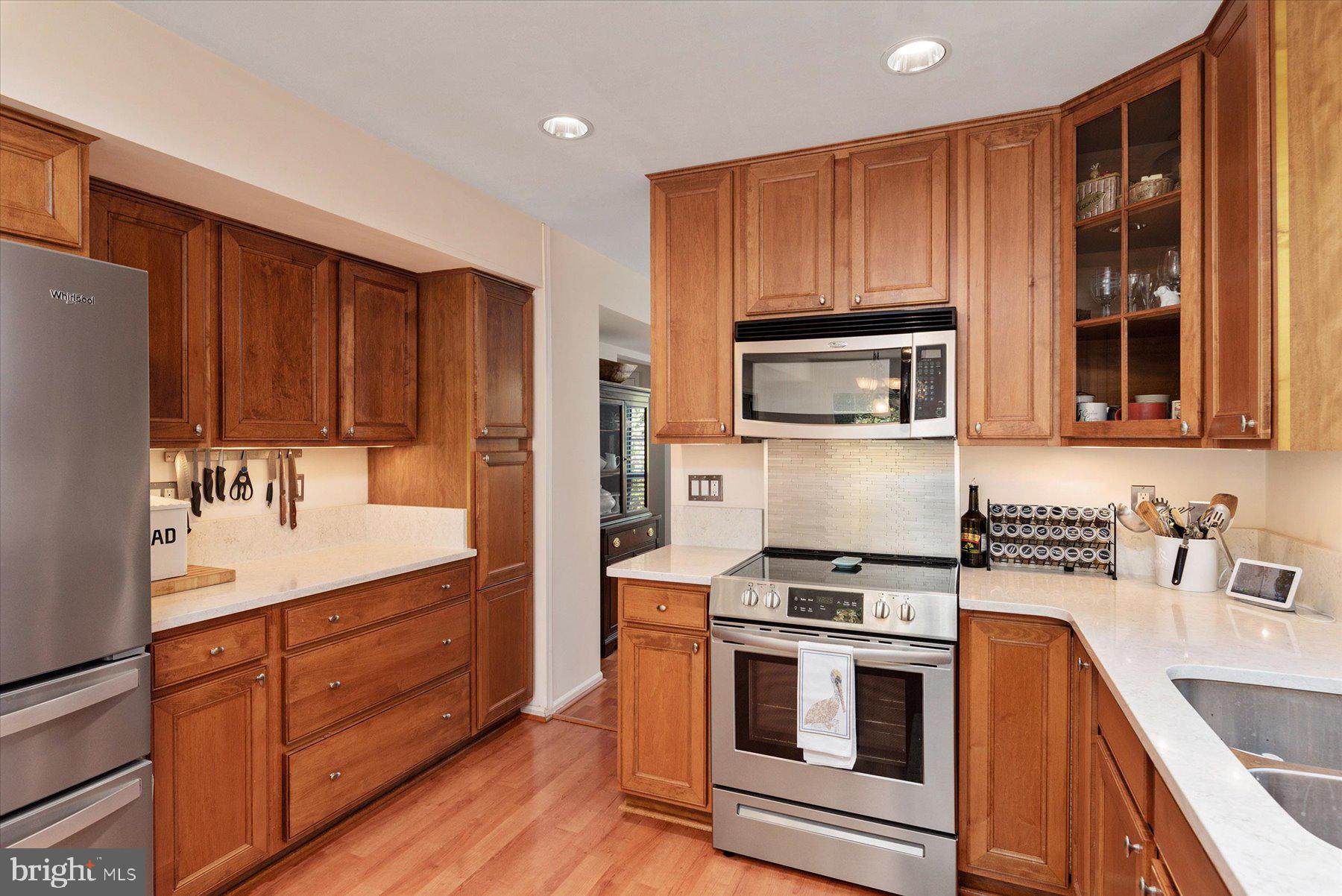 9337 Spring Water Path Jessup, MD 20794 - Photo 12 of 41 a kitchen with granite countertop wooden cabinets and stainless steel appliances