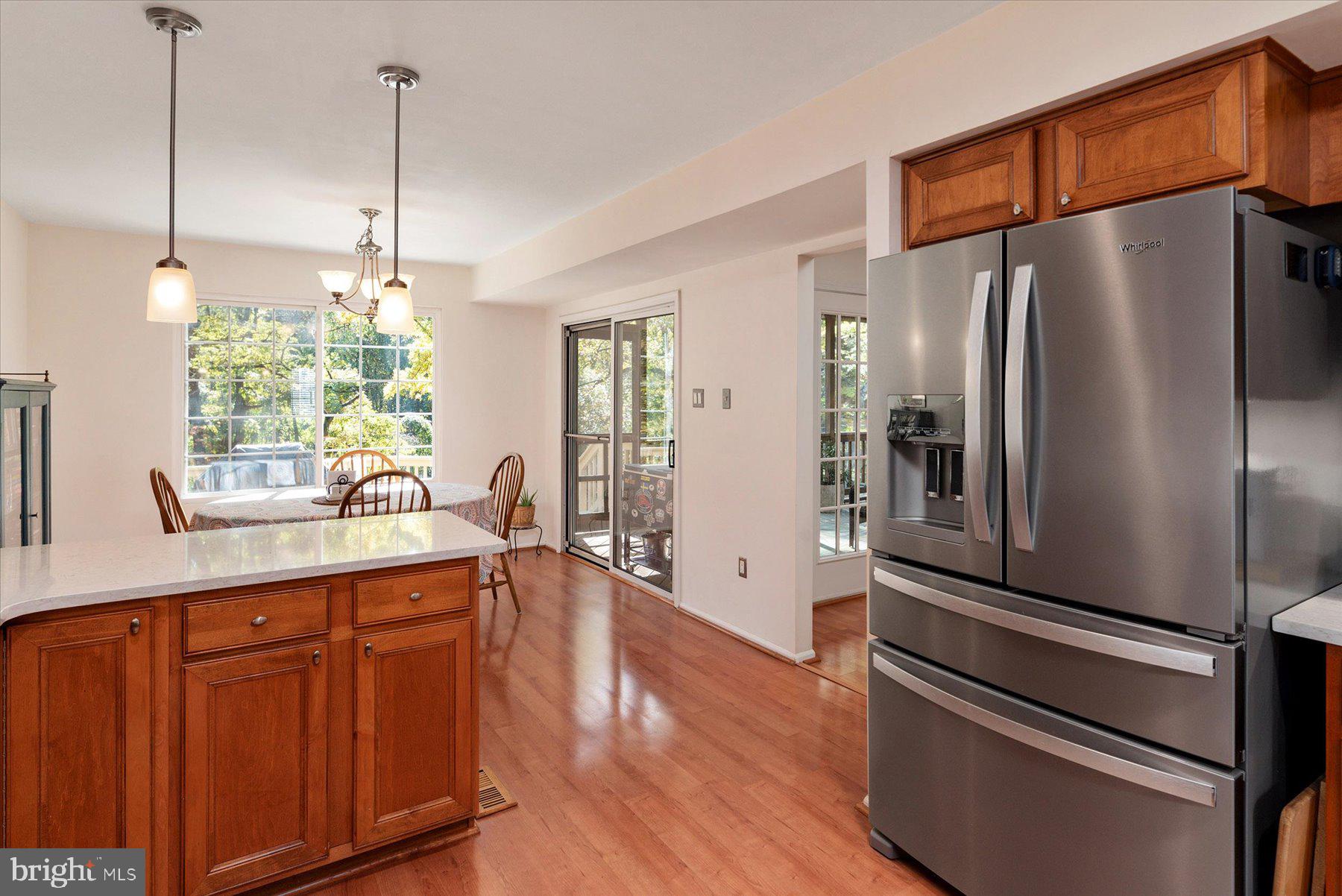 9337 Spring Water Path Jessup, MD 20794 - Photo 13 of 41 a kitchen with stainless steel appliances a refrigerator a sink cabinets and wooden floor
