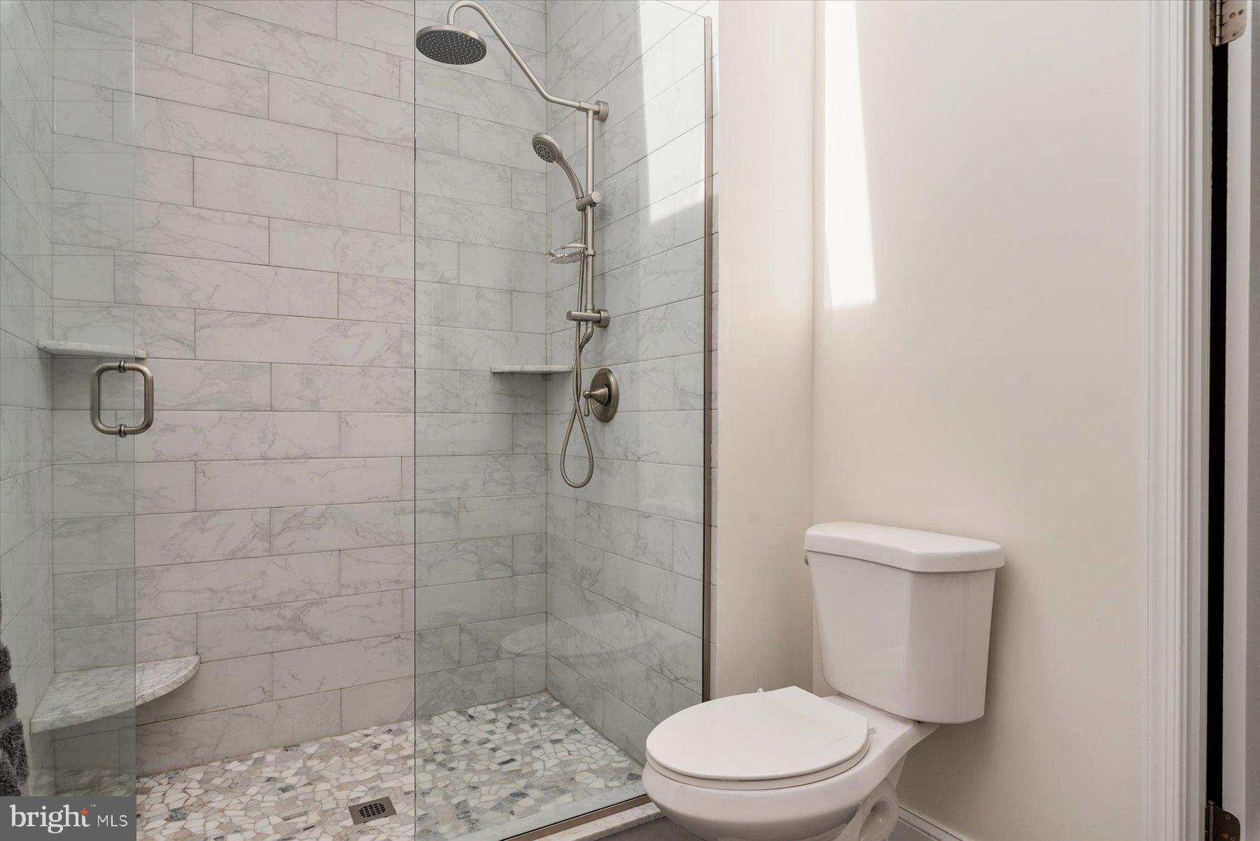 9337 Spring Water Path Jessup, MD 20794 - Photo 20 of 41 a white toilet sitting next to a shower