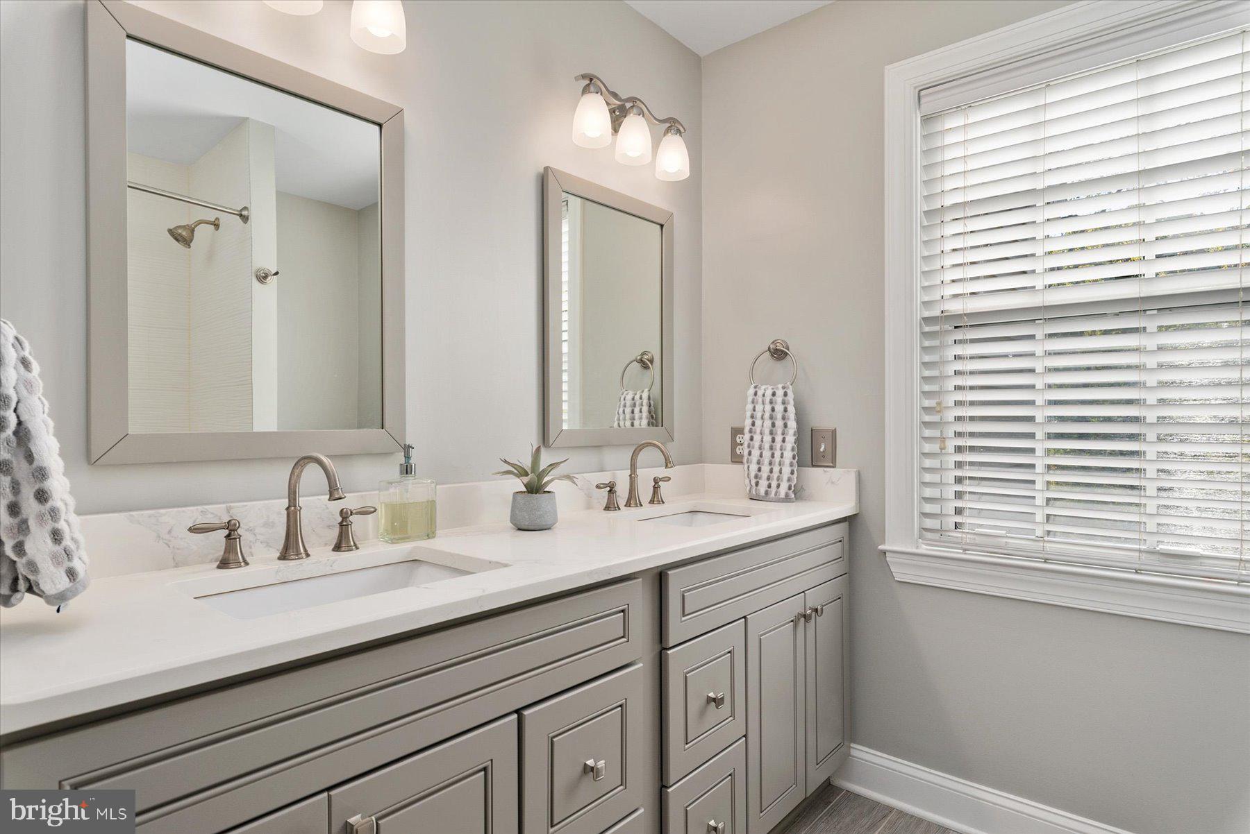 9337 Spring Water Path Jessup, MD 20794 - Photo 24 of 41 a bathroom with double sink and a mirror
