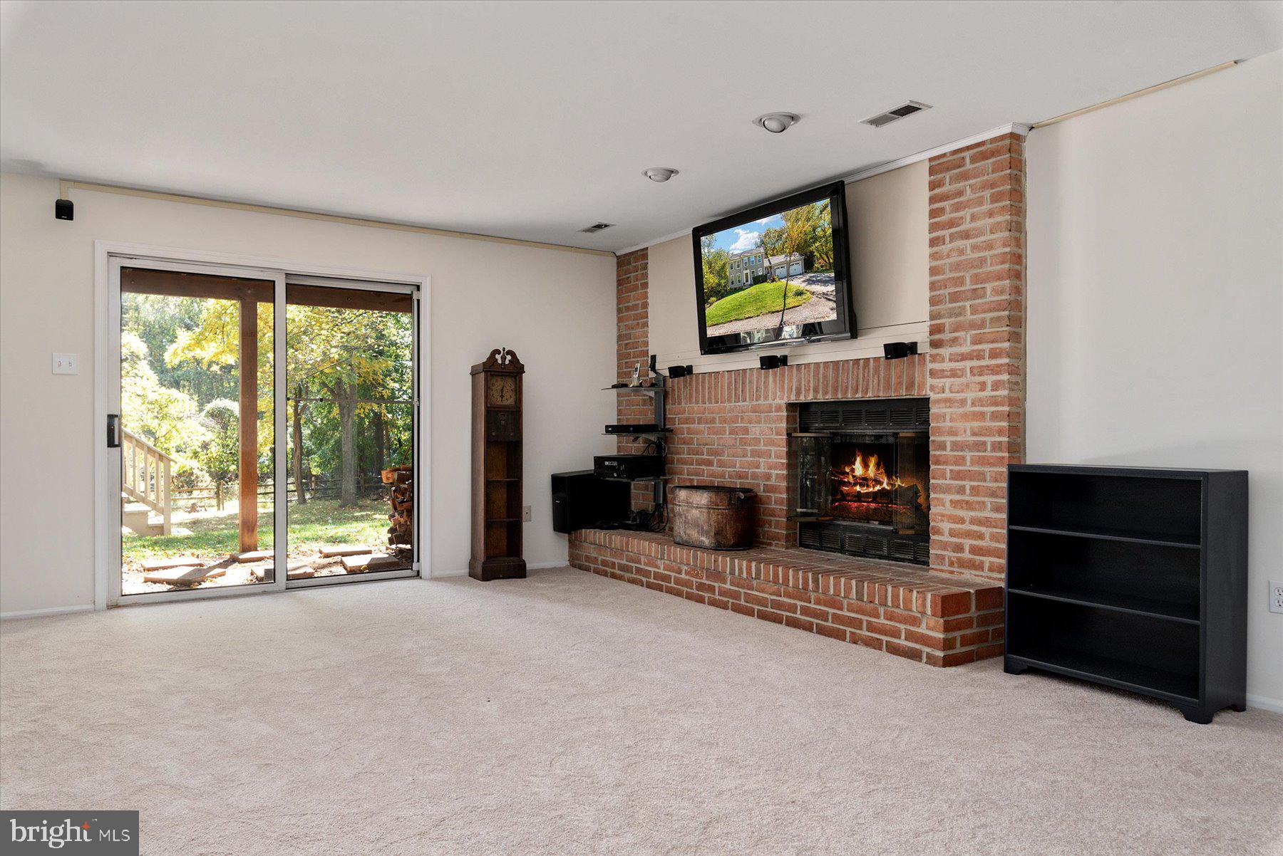9337 Spring Water Path Jessup, MD 20794 - Photo 27 of 41 a living room with fireplace furniture and a flat screen tv
