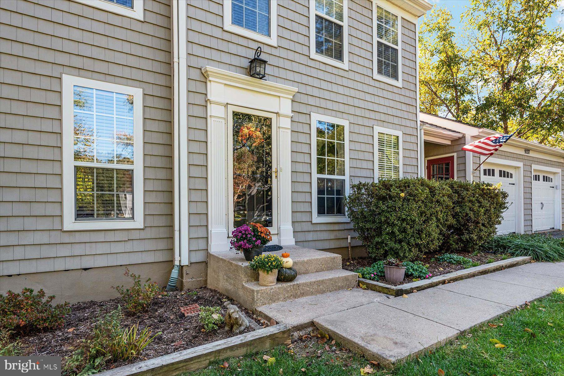 9337 Spring Water Path Jessup, MD 20794 - Photo 3 of 41 a view of a house with potted plants and a bench