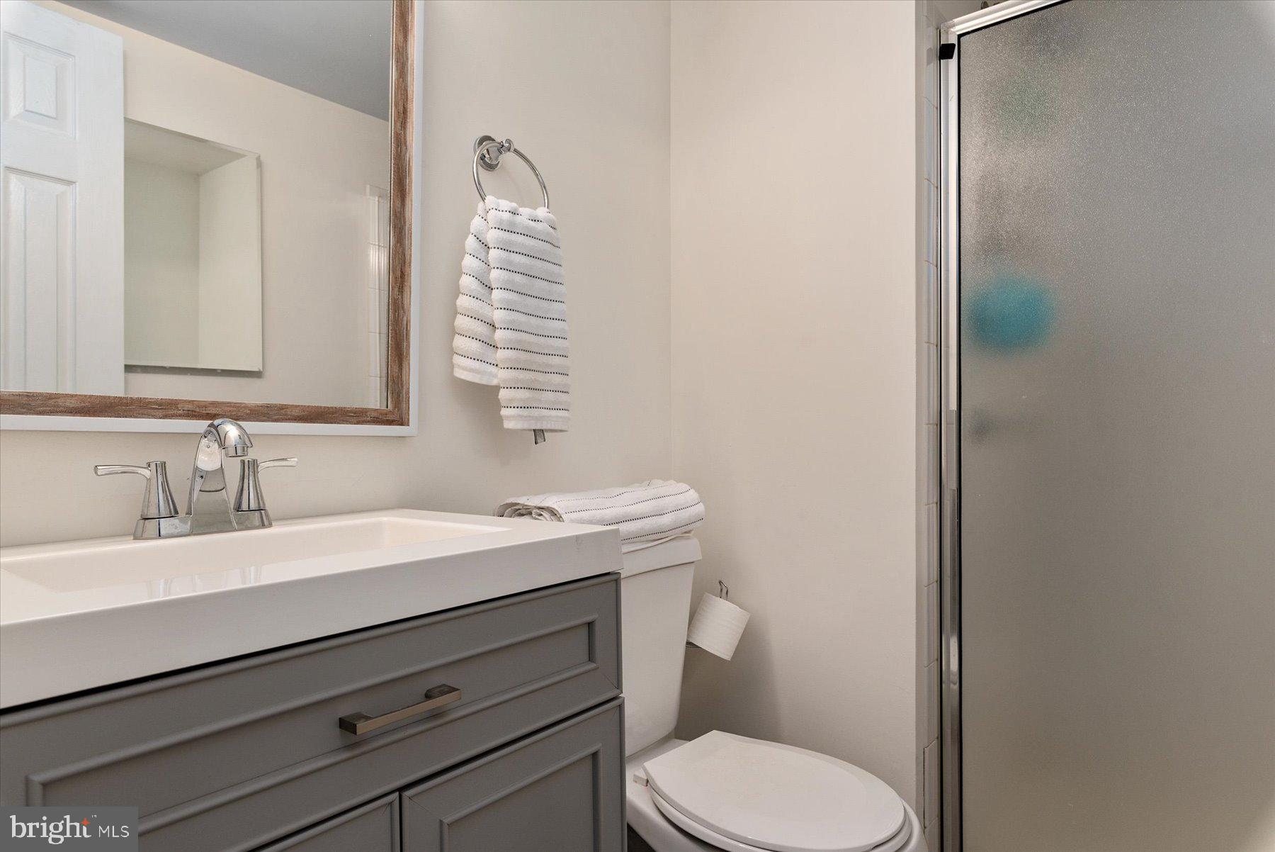 9337 Spring Water Path Jessup, MD 20794 - Photo 31 of 41 a bathroom with a toilet a sink and mirror