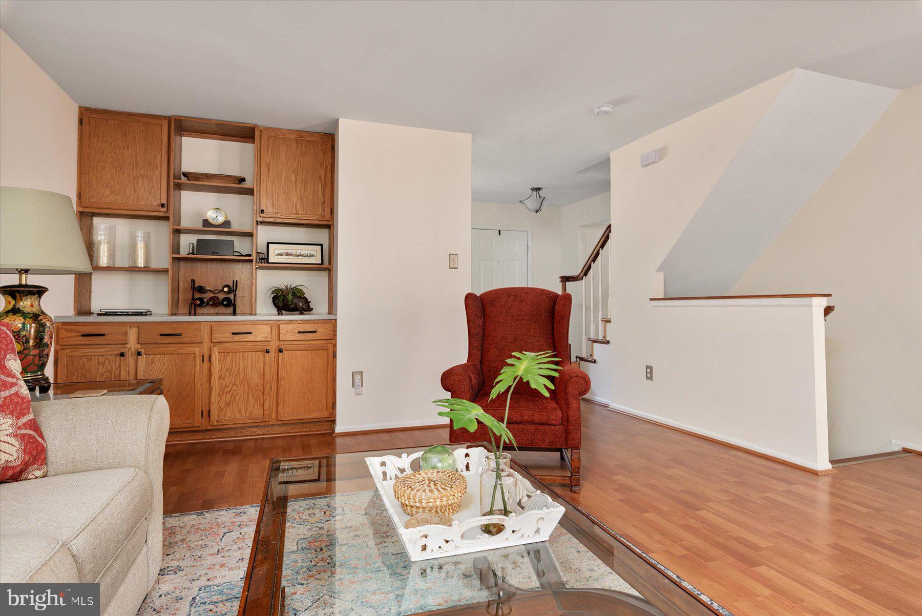 9337 Spring Water Path Jessup, MD 20794 - Photo 8 of 41 a living room with furniture a rug and a wooden floor