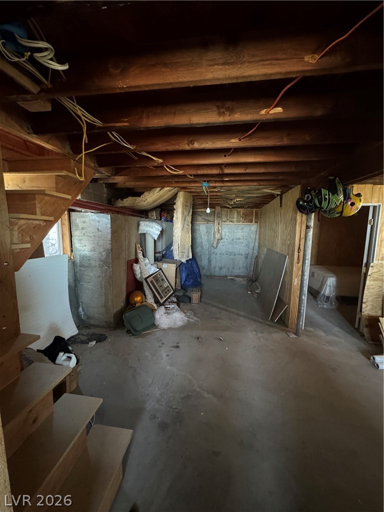 20996 Pinion Pine Road Pioche, NV 89043 - Photo 14 of 19 Unfinished basement space with wood framing and concrete flooring, ready for personalized development.
