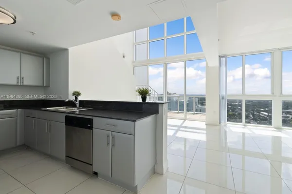 a kitchen with a sink and cabinets