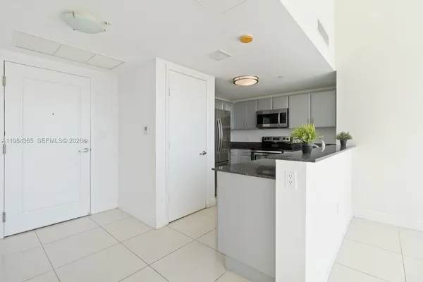 a kitchen with stainless steel appliances granite countertop a refrigerator and a stove
