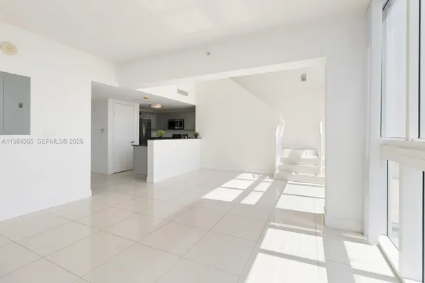 a view of a hallway with wooden floor and windows