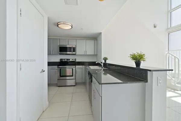 a kitchen with a sink a stove and refrigerator