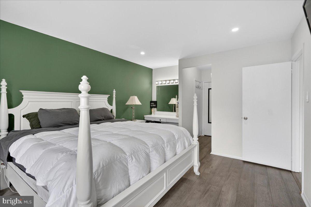 8930 Krewstown Road, Unit 310 Philadelphia, PA 19115 - Photo 18 of 32 a large bedroom with a bed and a chandelier