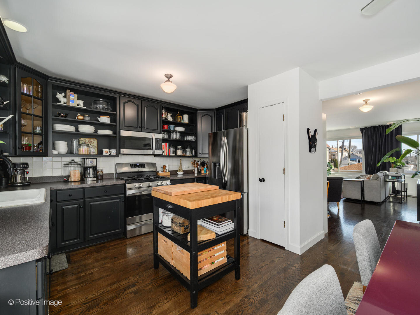 550 West 45th Street Chicago, IL 60609 - Photo 13 of 24 a kitchen with stainless steel appliances granite countertop a refrigerator and wooden cabinets