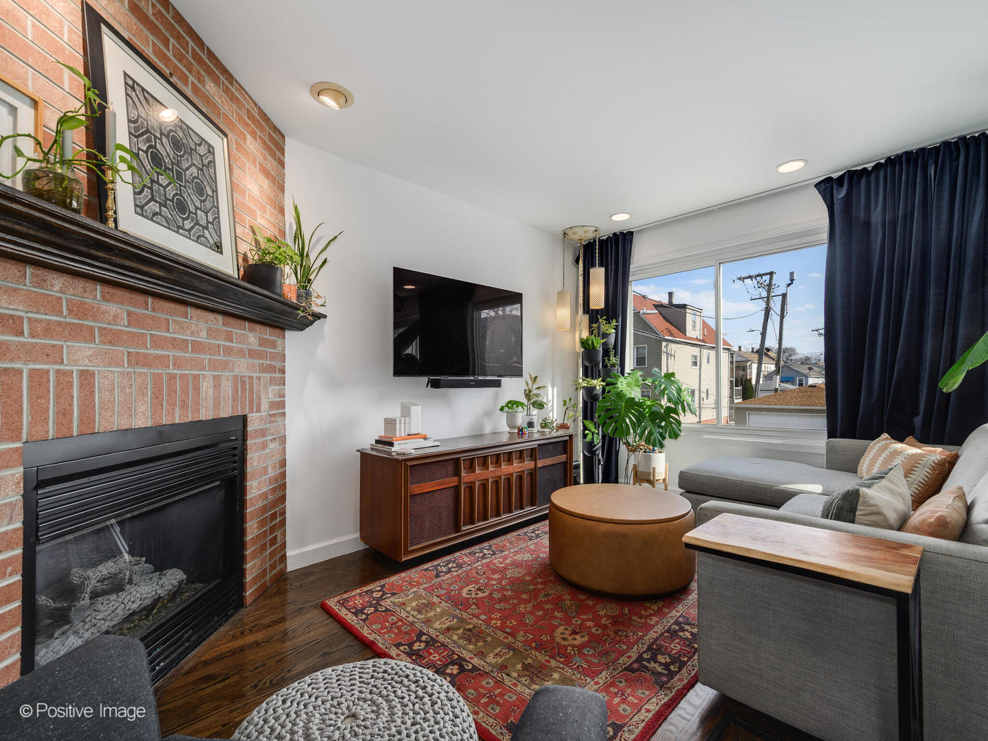 550 West 45th Street Chicago, IL 60609 - Photo 6 of 24 a living room with furniture a fireplace and a flat screen tv