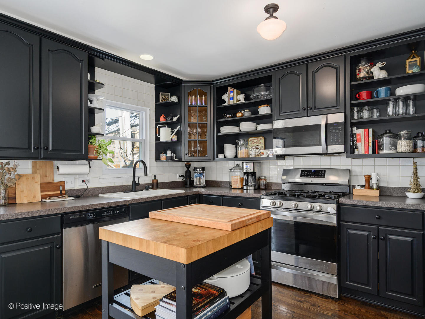550 West 45th Street Chicago, IL 60609 - Photo 8 of 24 a kitchen with stainless steel appliances granite countertop a stove and a sink