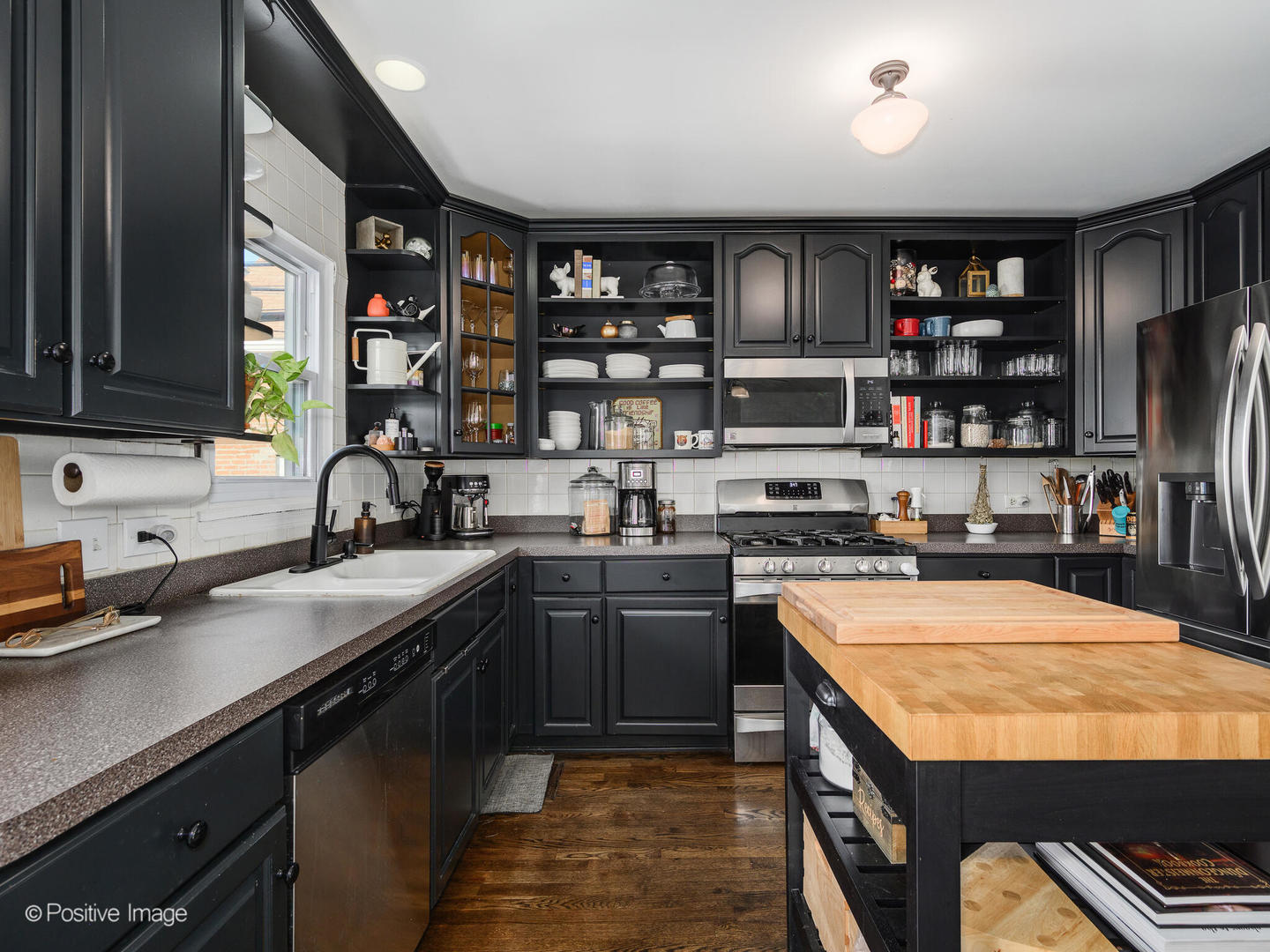 550 West 45th Street Chicago, IL 60609 - Photo 10 of 24 a kitchen with stainless steel appliances granite countertop a sink counter space cabinets and a window