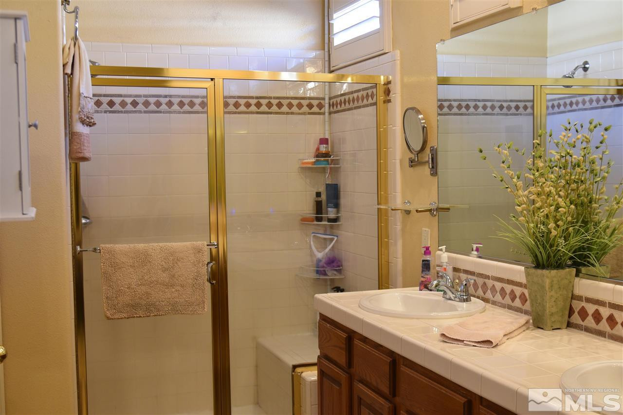 1186 Scenic Park Terrace Reno, NV 89521 - Photo 13 of 18 a bathroom with a sink a toilet and shower