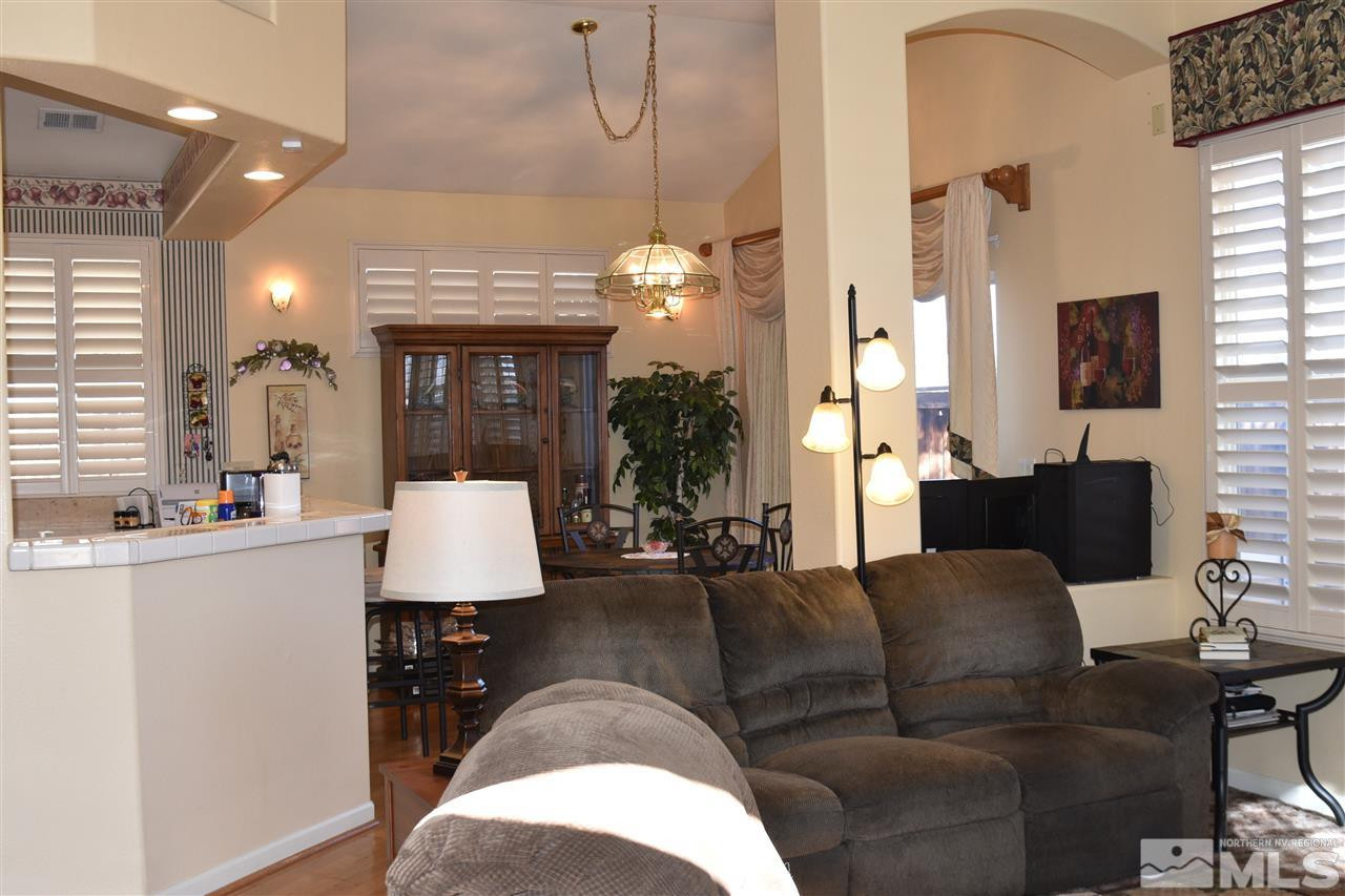1186 Scenic Park Terrace Reno, NV 89521 - Photo 3 of 18 a living room with furniture a chandelier and a flat screen tv
