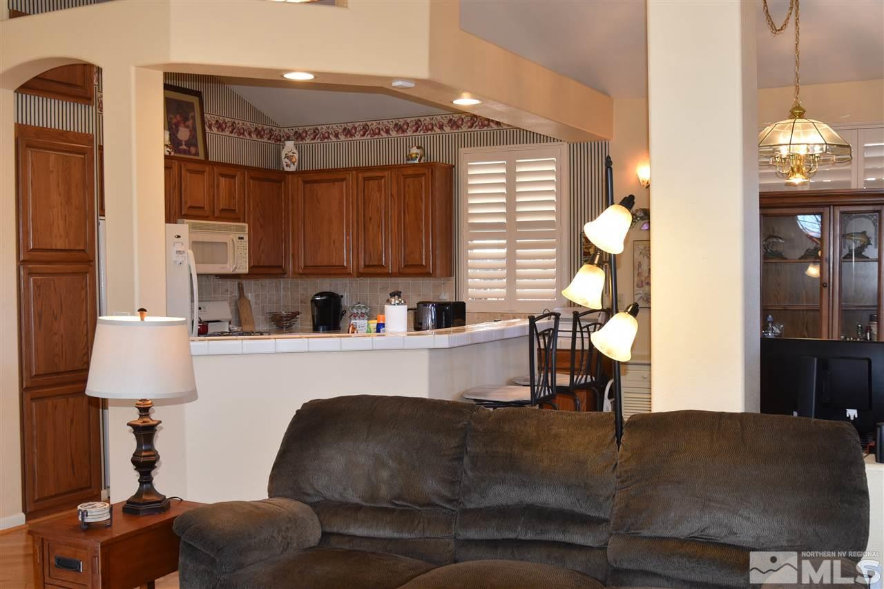 1186 Scenic Park Terrace Reno, NV 89521 - Photo 5 of 18 a living room with kitchen island furniture and a chandelier