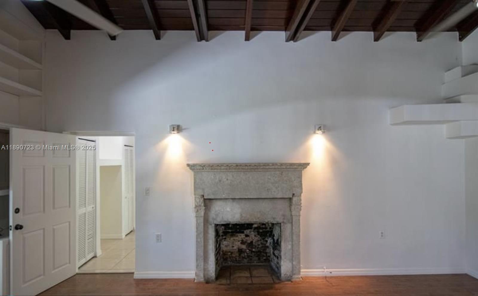 3050 Alton Road Miami Beach, FL 33140 - Photo 11 of 41 a room with a fireplace and a ceiling fan