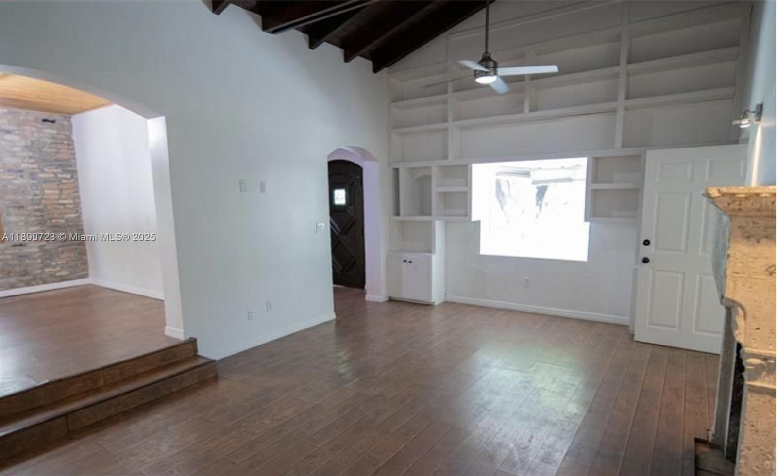 3050 Alton Road Miami Beach, FL 33140 - Photo 12 of 41 an empty room with wooden floor and windows