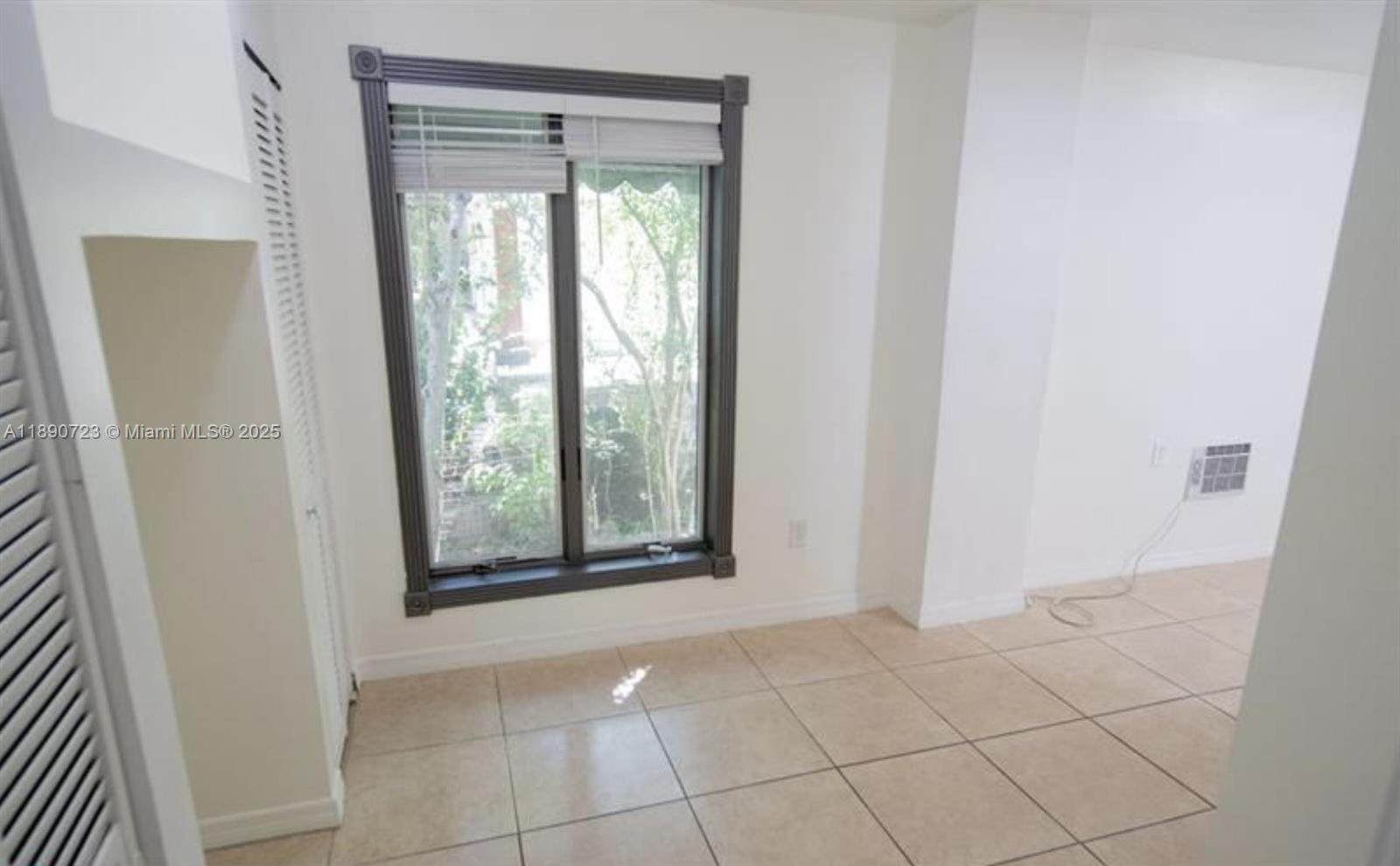 3050 Alton Road Miami Beach, FL 33140 - Photo 14 of 41 a view of an empty room with a window