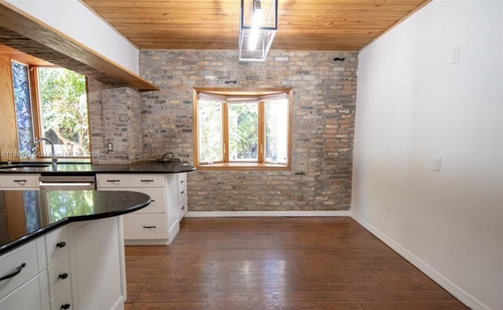 3050 Alton Road Miami Beach, FL 33140 - Photo 20 of 41 a bathroom with a granite countertop window a sink and a window