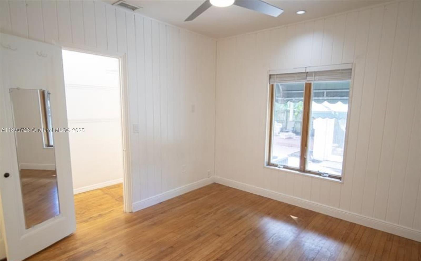 3050 Alton Road Miami Beach, FL 33140 - Photo 27 of 41 an empty room with wooden floor and a window