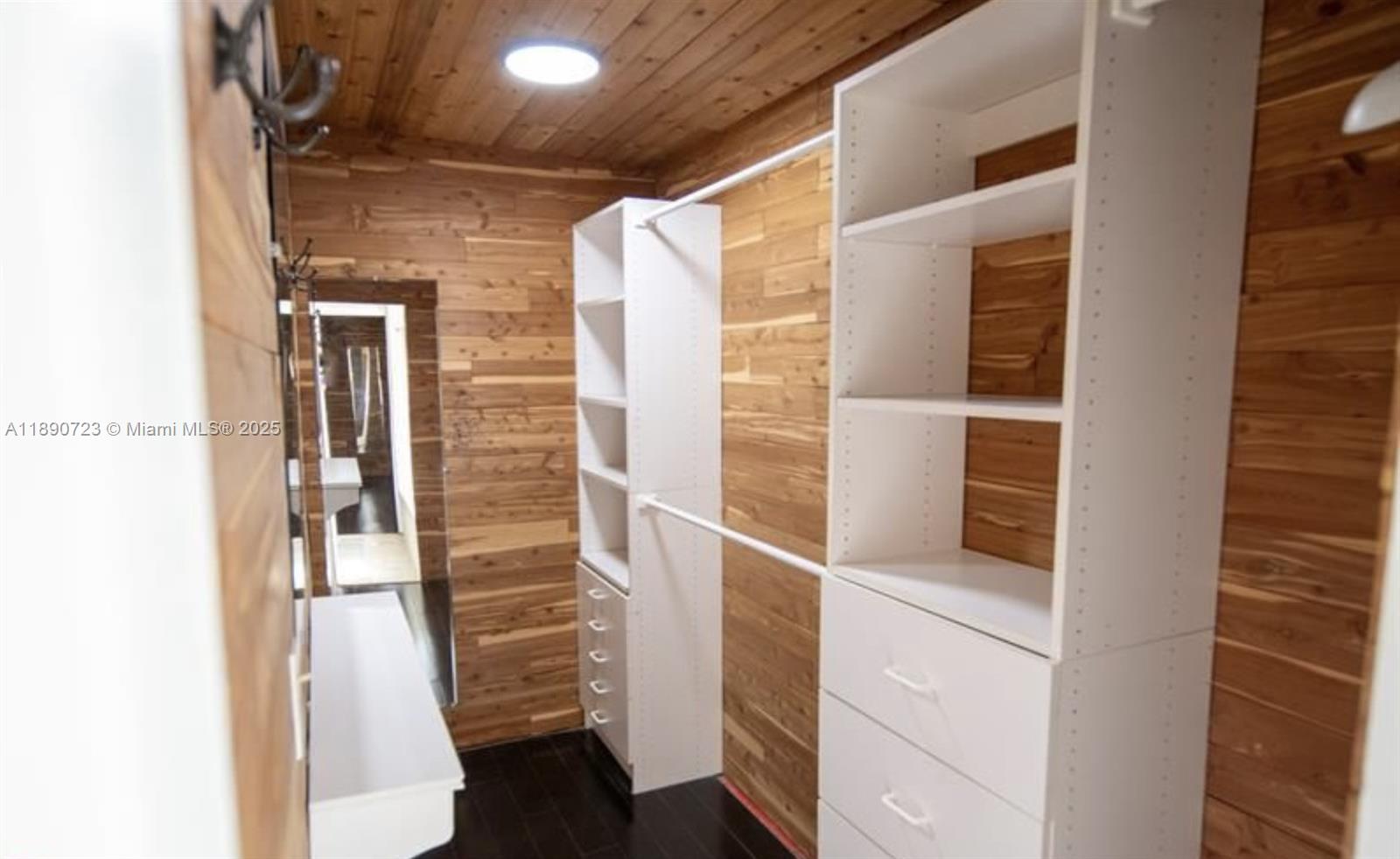 3050 Alton Road Miami Beach, FL 33140 - Photo 30 of 41 a view of walk in closet with empty racks