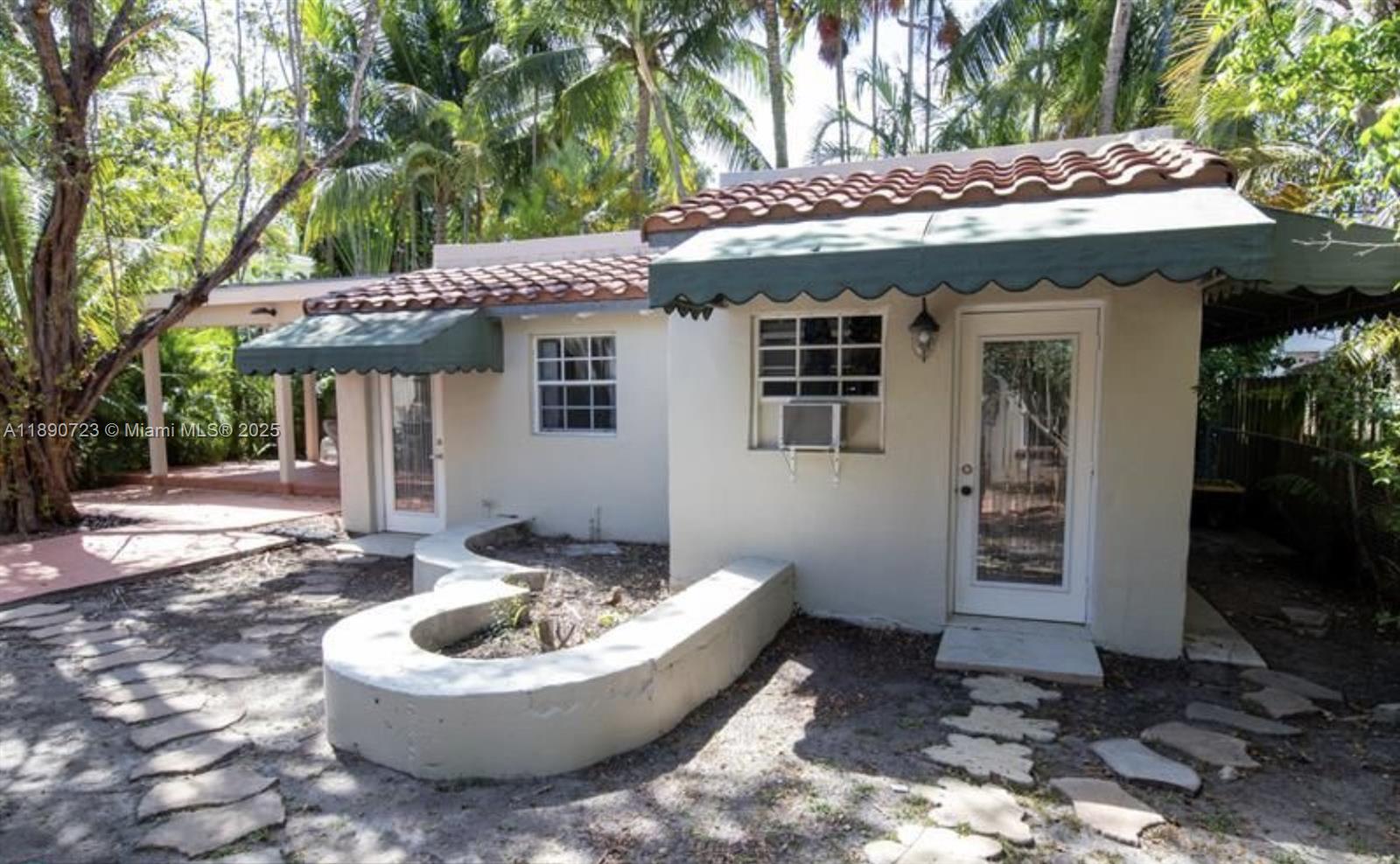 3050 Alton Road Miami Beach, FL 33140 - Photo 34 of 41 a view of a patio with table and chairs and potted plants