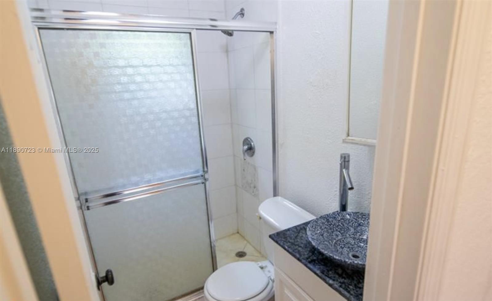 3050 Alton Road Miami Beach, FL 33140 - Photo 35 of 41 a bathroom with a granite countertop shower and a sink