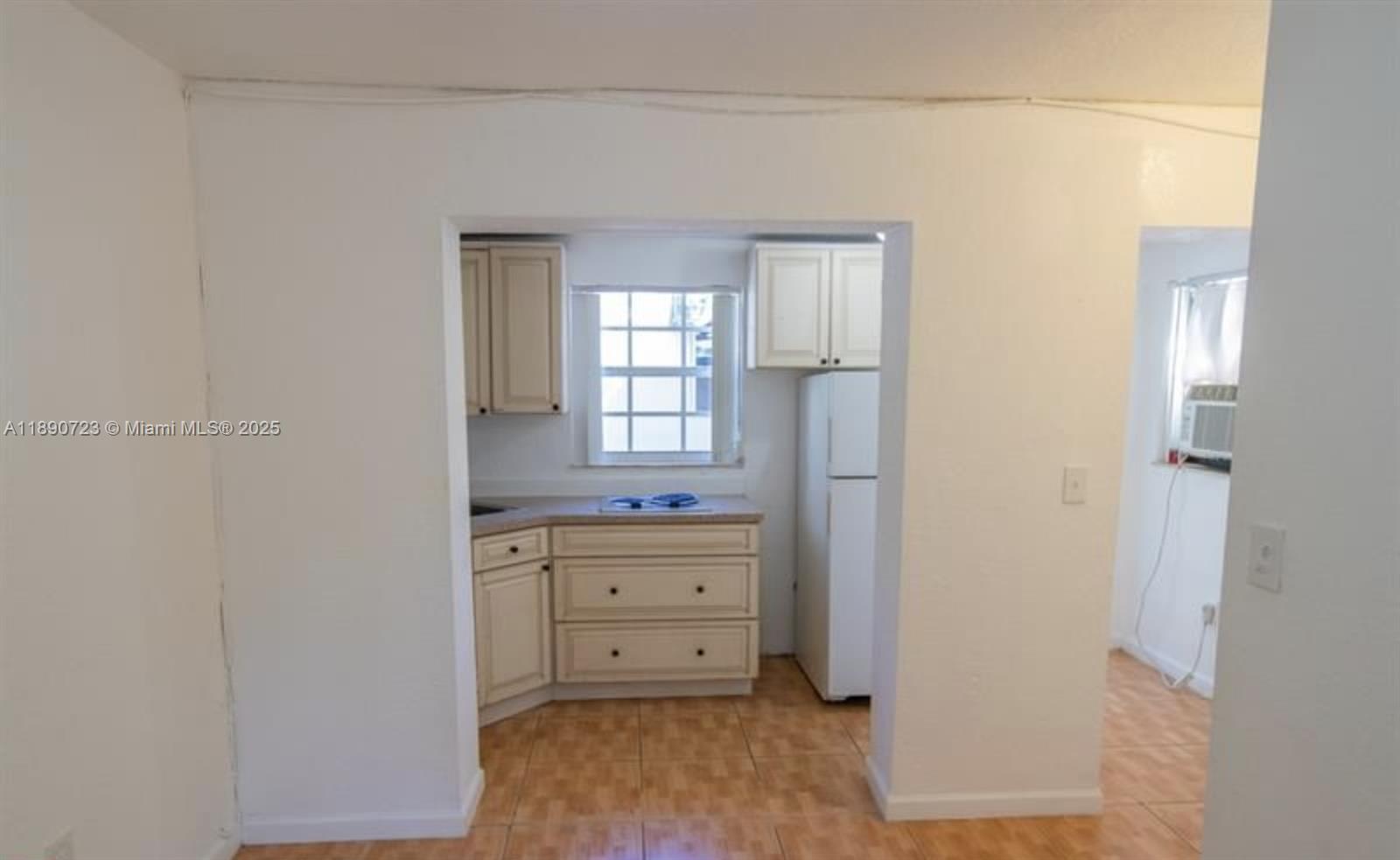 3050 Alton Road Miami Beach, FL 33140 - Photo 37 of 41 a room with a dresser and a window