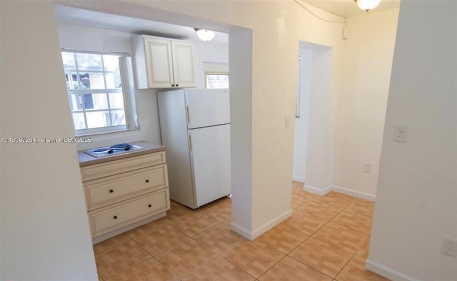3050 Alton Road Miami Beach, FL 33140 - Photo 38 of 41 a view of kitchen with a refrigerator cabinet a sink and dishwasher