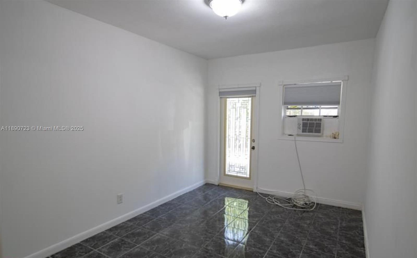 3050 Alton Road Miami Beach, FL 33140 - Photo 40 of 41 an empty room with windows