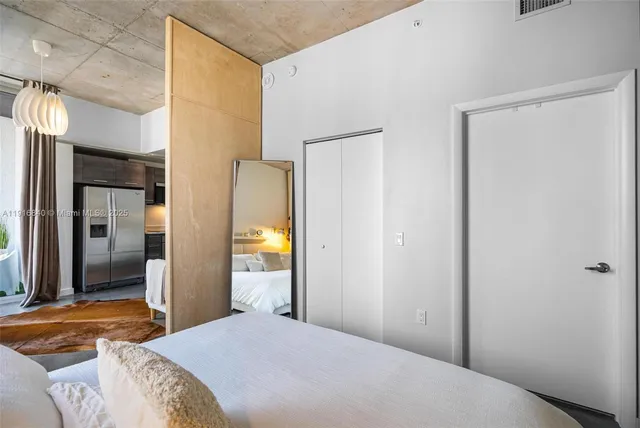 a bedroom with a bed and a lamp