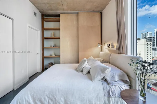 a bedroom with a bed and a potted plant