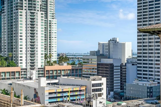a living room with furniture and stainless steel appliances
