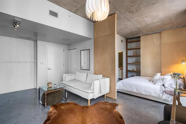 a bedroom with a bed and a chandelier