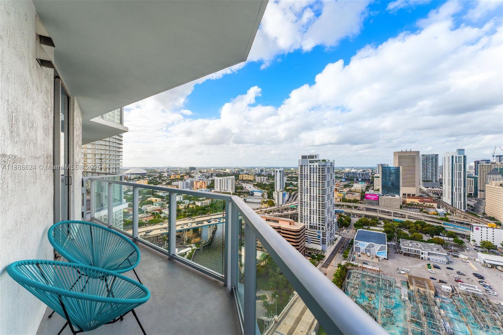 185 Southwest 7th Street, Unit 3605 Miami, FL 33130 - Photo 22 of 24 a view of a balcony with chairs