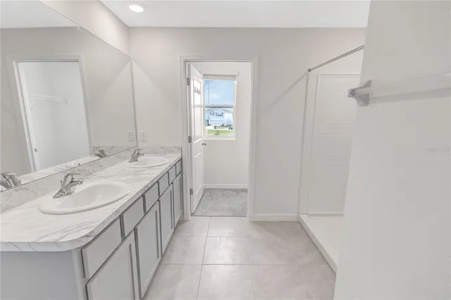 a spacious bathroom with a granite countertop sink a toilet and mirror