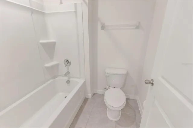a bathroom with a toilet and a bathtub