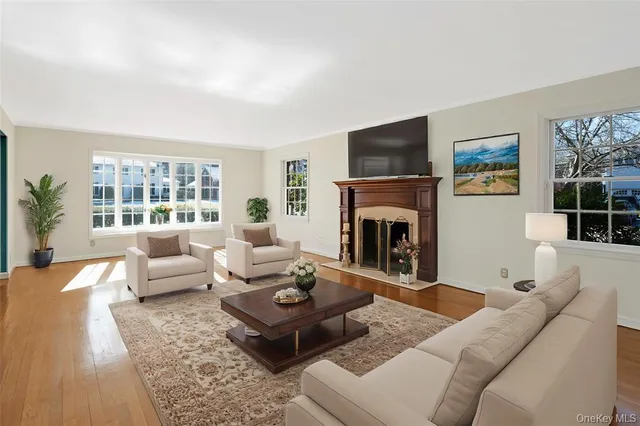 a living room with furniture a flat screen tv and a fireplace