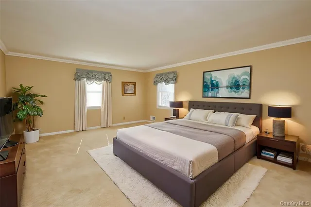 a spacious bedroom with a large bed and a potted plant