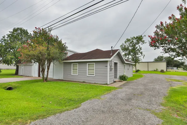a front view of house with yard and trees